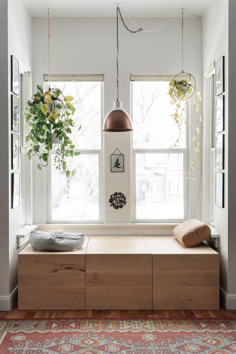 Avenues project — maple window seat storage bench with natural light and hanging plants