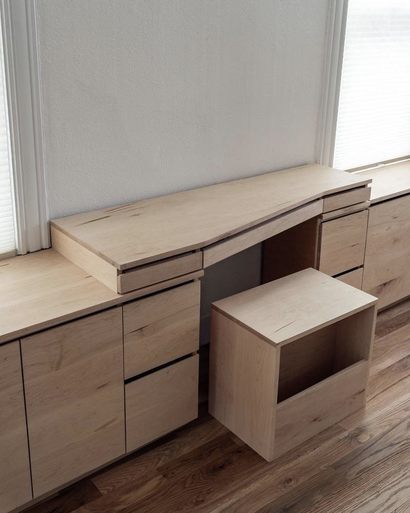 Avenues project — live-edge maple desk with integrated stool and storage cabinetry