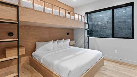 Deer Valley bunk room — modern white oak with black metal ladder, integrated shelving